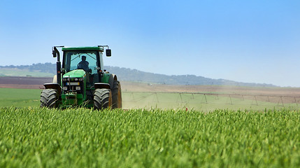 Image showing Green tractor working . 