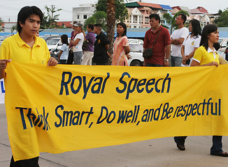 Image showing Thai people carry a banner to pay respect to the King during a p