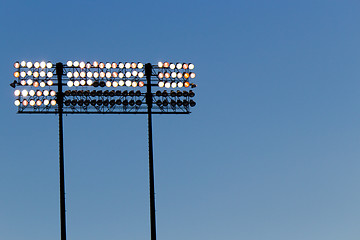 Image showing Stadium lights over a blue sky