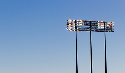 Image showing Stadium lights over a blue sky