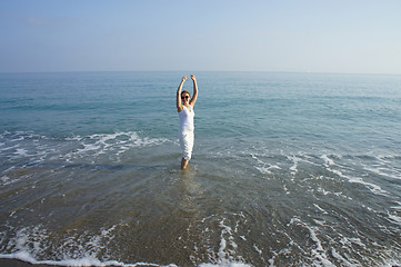 Image showing Young woman dancing on the beach