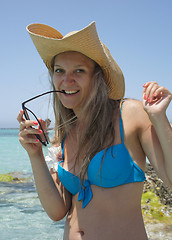 Image showing Azure sea and young woman in traw hat                      