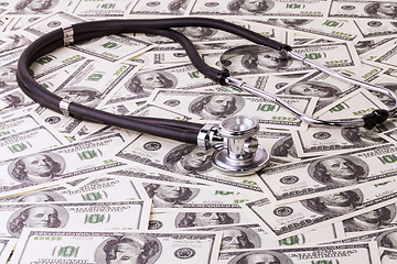 Image showing Stethoscope and dollars