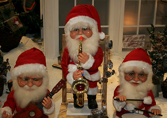 Image showing three santas playing