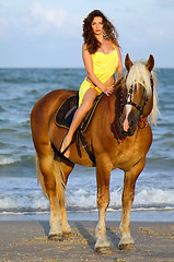 Image showing Beautiful young woman riding a horse