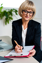 Image showing Secretary jotting down notes and instructions