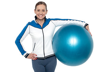 Image showing Pretty woman holding big blue pilate ball