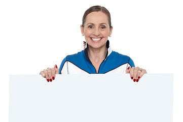 Image showing Charming woman holding blank whiteboard