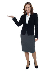 Image showing Cheerful executive presenting copy space