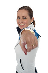 Image showing Cheerful woman standing sideways and pointing at you