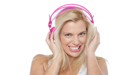 Image showing Hot blonde listening to music via headphones