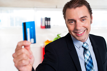 Image showing Handsome male executive holding cash card