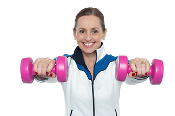 Image showing Female working out with pink dumbbells