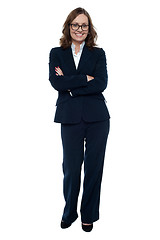 Image showing Executive in business attire standing arms folded