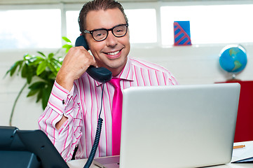 Image showing Happy executive engaged on a business call