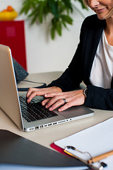 Image showing Cropped image of female manager working on laptop