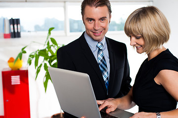 Image showing Secretary showing power point presentation to the boss