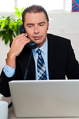 Image showing Man in formal attire talking on the phone