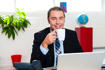 Image showing Boss enjoying hot coffee during work break