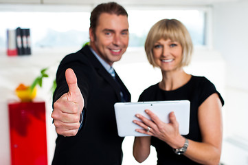 Image showing Secretary with a tablet posing with her successful boss