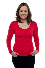 Image showing Middle aged woman in bright red top