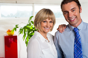 Image showing Cheerful business couple in their new office