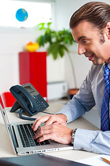 Image showing Businessman typing report on a laptop