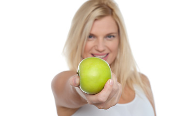 Image showing Glamorous blonde offering you juicy green apple