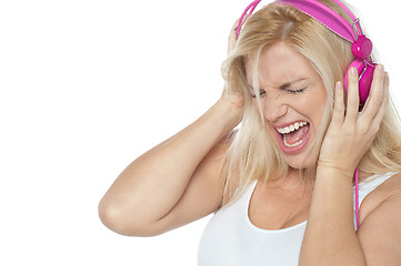 Image showing Blonde screaming while listening to rock music