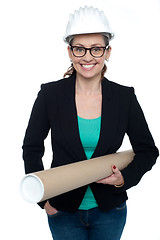 Image showing Confident female architect carrying blueprints