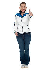 Image showing Casual charming woman gesturing thumbs up