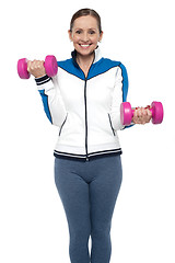 Image showing Active woman posing with dumbbells