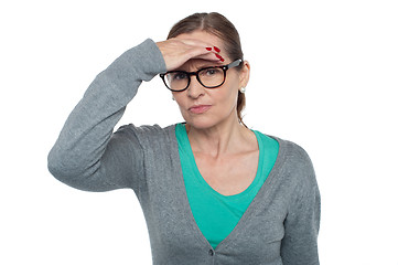 Image showing Expressionless woman looking at distance object