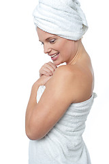 Image showing Female wrapping herself in towel after hot spa