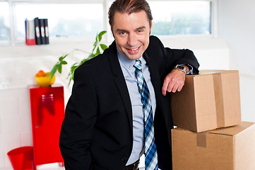 Image showing Middle aged businessman at his relocated office