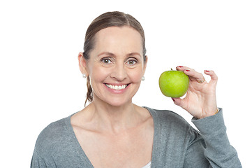 Image showing Health conscious woman holding fresh green apple