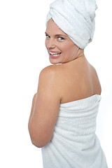 Image showing Hot woman in bath towel turning back towards camera