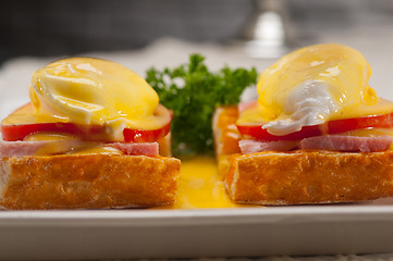 Image showing eggs benedict on bread with tomato and ham