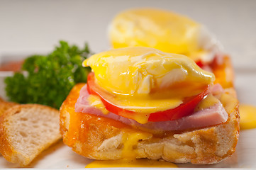 Image showing eggs benedict on bread with tomato and ham