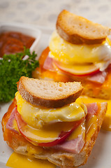 Image showing eggs benedict on bread with tomato and ham