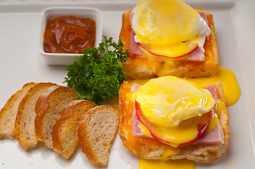 Image showing eggs benedict on bread with tomato and ham