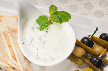 Image showing Greek Tzatziki yogurt dip and pita bread