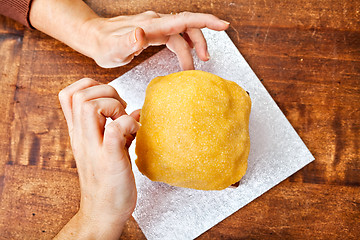 Image showing Hands decorating christmas cake from above