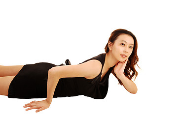 Image showing Asian girl lying on floor.