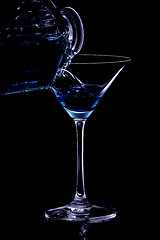 Image showing Pouring a drink in the night