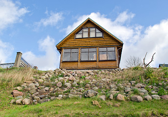 Image showing wooden homestead house hill stone blue cloudy sky 