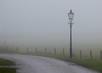 Image showing Lantern at a misty road