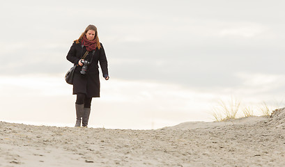 Image showing Lonely photographer walking on a beach