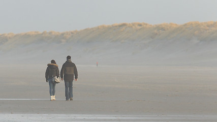 Image showing Couple walking on a dutch beach