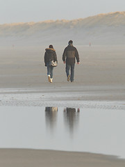 Image showing Couple walking on a dutch beach